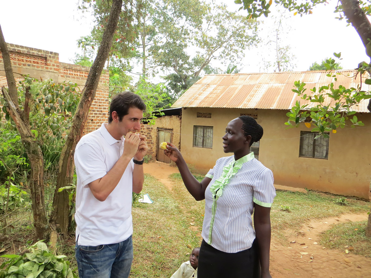 Kiva Fellows are adventurous: Christine introduces Matt Ramirez to jackfruit, a enormous, spiky fruit that is bountiful in Uganda.