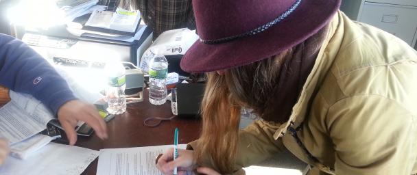 Jessie signing documents for her new truck - soon to become the wandering food truck of New York fashion